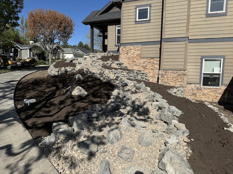Sustainable side yard using a dry creek landscape design to replace grass and plants.